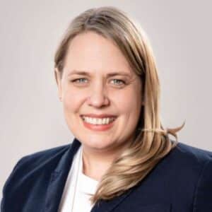 headshot of woman with blonde hair in black blazer