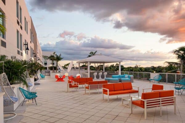 a rooftop with seating area and a beautiful sky
